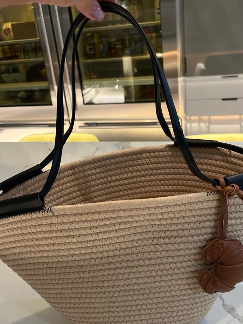 Woven Straw Tote Bag with Black Handles and Brown Charm